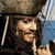 Pixelated image of a character with long dark hair and a tricorn hat, holding a finger to lips, with red text on a black background.