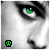 A grayscale close-up of a person's eye and nose with green eyes, featuring a pixelated skull icon in the corner that alternates between black and green.