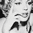 Black-and-white pixelated image of a woman with styled hair, wearing a sleeveless dress and earrings, shown in multiple overlapping poses.