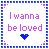 Pixelated icon with text 'I wanna be loved' in purple letters and a blue heart symbol on a light background.