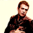 Static pixelated image of a person with brown hair wearing dark clothing against a light background, rendered in low-resolution 256x256 pixels.