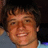 Pixelated portrait of a smiling person with dark hair on left, blue background with white text on right.