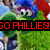 Pixelated image of a green cartoon character with large eyes and blue hair, overlaid by red text reading 'GO PHILLIES!' on a black banner.