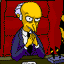 Yellow-skinned cartoon character with white hair in a blue suit and black tie sits at a desk against red brick background, hands clasped near face.