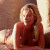 A pixelated image of a person with long blonde hair lying on their stomach, next to green text reading 'Original Icons .com' in bright green letters.