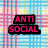 Pixelated text 'ANTI SOCIAL' in bright pink on black rectangular blocks against a multicolored grid background.