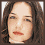 Four pixelated portrait views of a person with brown hair and red lips in different poses, arranged in a