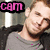 Pixelated image of a person with light skin and brown hair wearing a gray shirt, positioned next to pink text reading 'C8m' on black background.