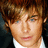 Pixelated image of a person with brown hair and light eyes on the left, next to bright green background with pink text reading 'he is so hott' on the right.