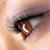 A close-up of a human eye with brown iris and visible eyelashes, showing subtle changes in eye position across four