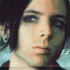 Four- of a person with dark hair and blue eyes in various poses, some contain text overlays