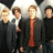 Four people in dark clothing stand against a light background with green text reading "i LOVE" and "Rough Draft" on blue and gray