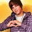 Pixelated image of a person in a purple jacket over a white shirt, making a hand gesture against a yellow background with bold text reading "Tahlia Beiber".