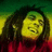 Pixelated portrait of a person with dark curly hair, yellow-toned face, and red clothing against a green-yellow gradient background.