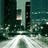 Pixelated cityscape with tall buildings and reflective water surface under muted teal and gray tones.