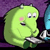Pixelated green cartoon character with pink cheek, two small horns, and wide eyes holding a blue object against purple background.