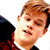 Static 50x50 pixel icon showing a close-up of a person's face with light brown hair, wearing dark clothing and red accents against a white background.