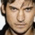 A pixelated close-up of a person's face with dark hair and light skin, showing subtle expression changes across four views.