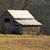A pixelated image shows a dark vehicle with a white canopy on a light brown ground against a dark background.