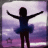 Silhouette of a dancer in blue tutu with arms raised against purple and white gradient background.