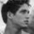 Black-and-white pixelated portrait of a person with dark hair on left; bright orange background on right displays white text "Albert Reed <3".