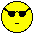 Two identical pixelated yellow emoji faces with black sunglasses and straight-line mouths on a gray background.