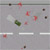Pixelated static image with scattered colored dots and horizontal white bars on a gray background.