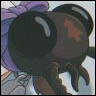A close-up of a cartoon character with large dark eyes, a purple bow, and a black top with a red emblem, set against a light background.