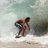 Pixelated beach scene with a figure in motion holding an object, next to blue text reading "Paulo Prietto" on white background.