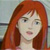 Pixelated image of a person with long red hair and light skin, wearing a light-colored top against a blurred background.