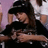 A pixelated image shows a person with long dark hair wearing black clothing, embracing another figure against a red background with white text reading "I Love Tom Kaulitz".