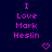 Dark blue background with repeated pink text "I Love Mark Heslin" and pixelated hearts, arranged in a pattern