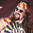 Pixelated static image of a cartoon character with exaggerated facial features wearing a colorful striped headband and dark clothing against a dark background.