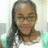 A pixelated static image shows a person with long dark hair, light skin tone, and closed eyes wearing glasses and a white top against a blurred background.