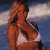 Pixelated static image of a person in swimwear against a blurred background with light and dark blue tones.