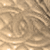 A static pixelated image with a beige and brown color palette showing abstract swirling patterns and scattered light spots.
