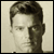 Static grayscale portrait of a person with short dark hair and visible facial features in pixelated style.