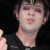 A 50x50 pixel animated contact sheet showing four frames of a person with dark hair and red eyeshadow in performance attire, paired with text reading "i luv it when he Smiles" and "Zacky Vengeance" on a white background.