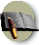 Animated sequence showing a book with text and a pen, transitioning from closed to open states against a light background.