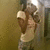 Animated sequence of a figure in light-colored clothing against a muted brown background with subtle lighting changes.
