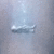 A static pixelated image with a light blue and gray gradient background featuring faint horizontal lines.
