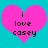 Two identical pink heart shapes on a cyan background, each containing black pixelated text reading "i love casey".