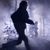 Silhouette of a figure in mid-stride walking left to right against a pixelated light blue and gray background.