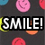 Pixelated text and smiley icons on a dark background with a gray overlay.
