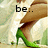 A pixelated image of a person's legs in green high-heeled shoes, with text reading "be..." and "spontaneous." on the left and right sides.