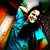 Pixelated image of two figures in close embrace, one with light hair and blue clothing, the other with dark hair and a black top, against a dark background with orange and green accents.
