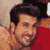 Static 50x50 pixel icon showing a close-up of a person with dark hair and facial stubble wearing a red garment against a light background.
