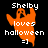 Pixelated orange ghost with raised arms over black background, text 'Shelby loves halloween =]' in white pixel font.