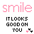 Pixelated pink 'smile' text above black block letters reading 'IT LOOKS GOOD ON YOU', with two small heart symbols, on a white background.