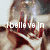 A pixelated image of a person with hands covering their face, displaying text overlays in white and pink.